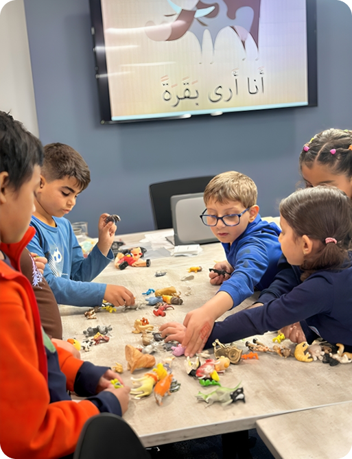 Children using story figures in an Arabic class