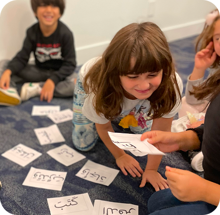 Children practicing Arabic cards