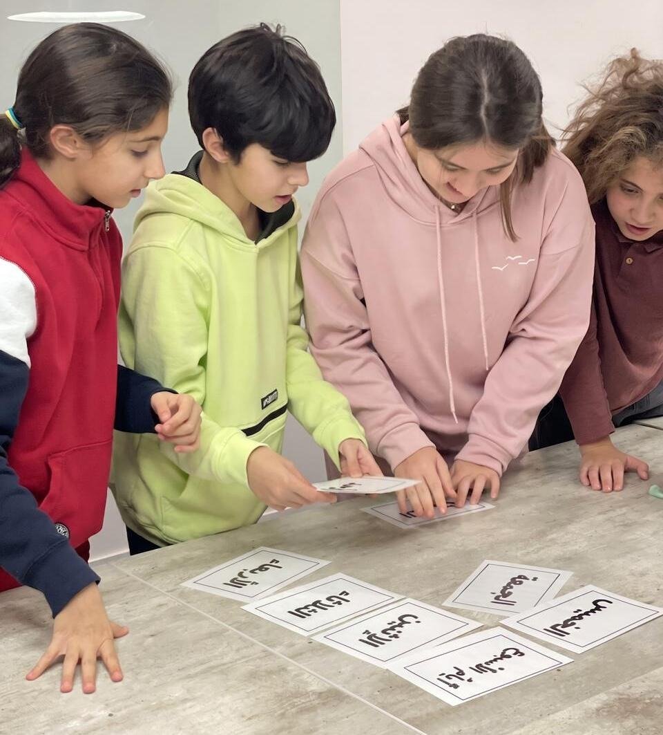 Children learning Arabic with a teacher