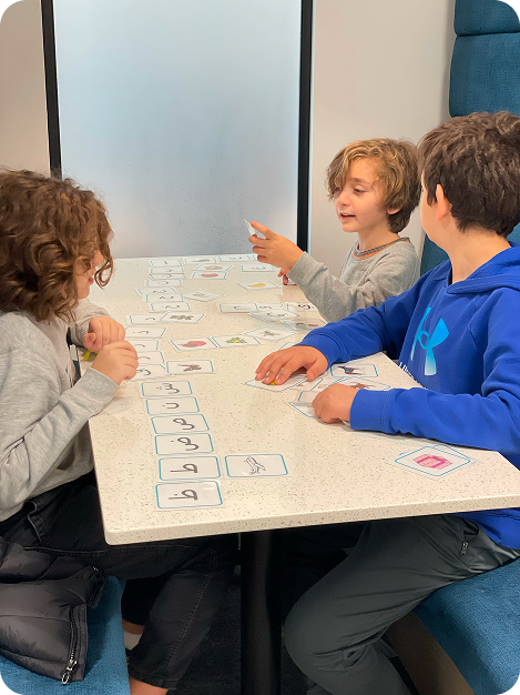 Children learning Arabic together at a table